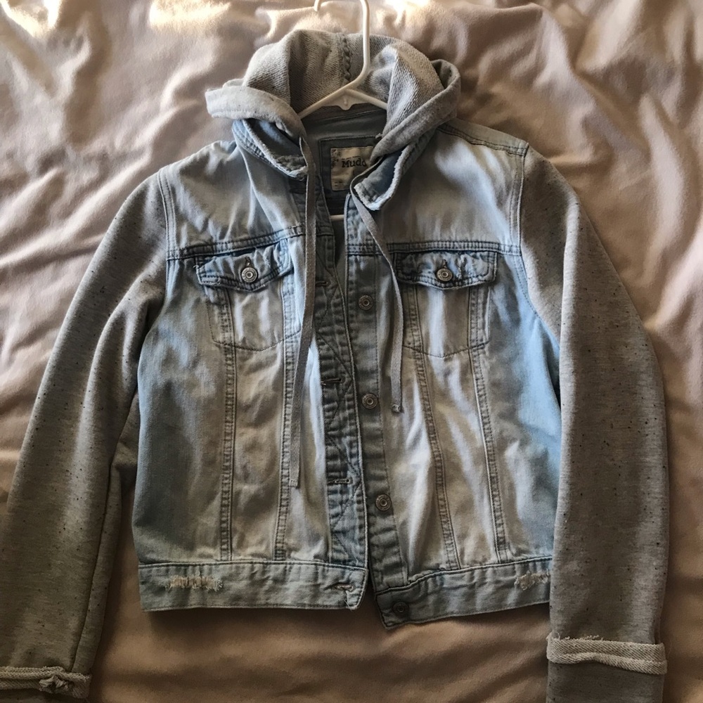 Jean jacket with sweater material sleeves.